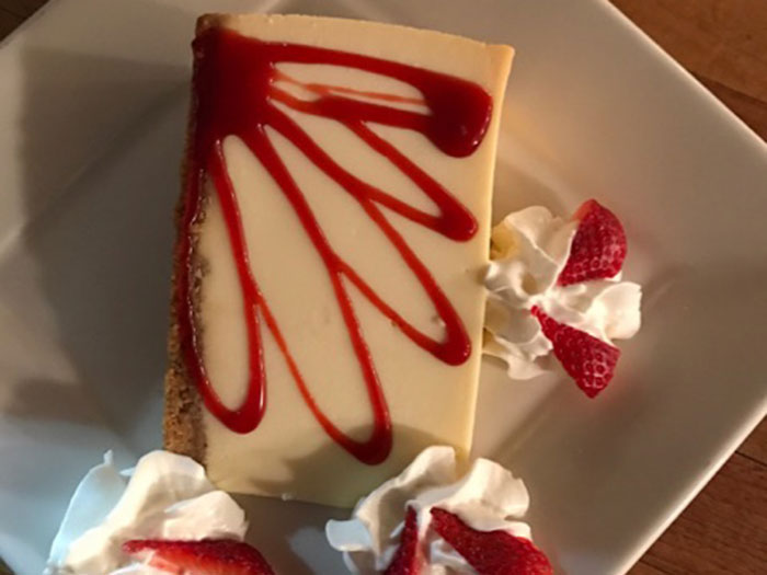 NEW YORK CHEESECAKE w/ STRAWBERRY SAUCE